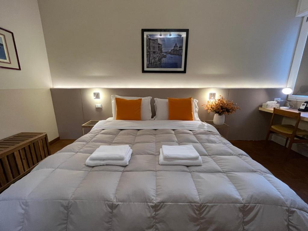 a bedroom with a large bed with orange pillows at Cà di Buole A in Mestre