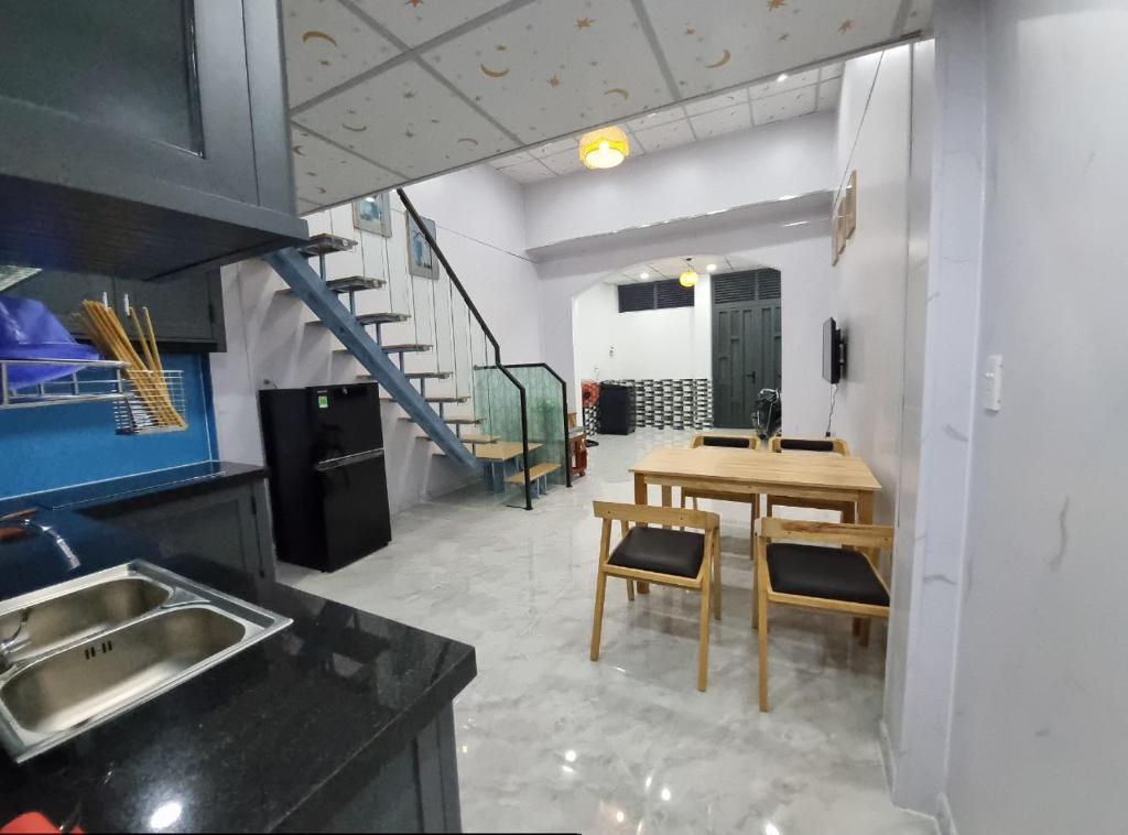 a kitchen with a table and a dining room at Homestay nguyên căn Ngọc Vân in Ho Chi Minh City