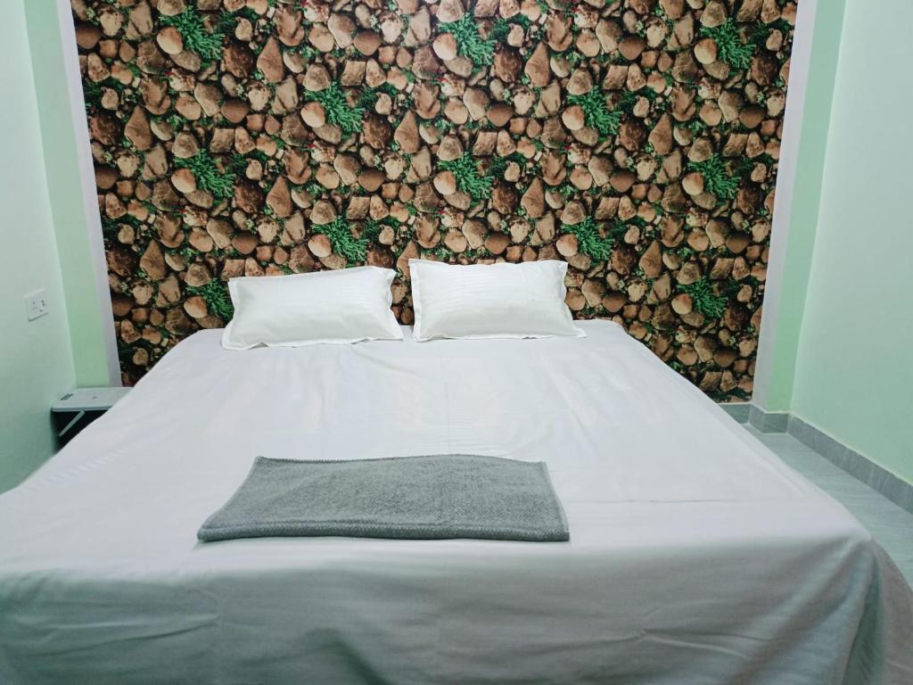 a bedroom with a bed with a wall of logs at Siya home stay in Faizābād