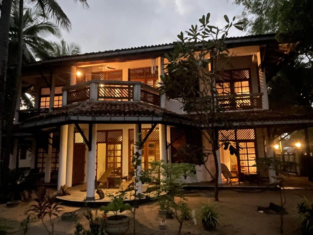 a large house with a balcony in front of it at 1 Floor Family Appartement with Balcony Villa Wonne Beachhouse in Arugam Bay