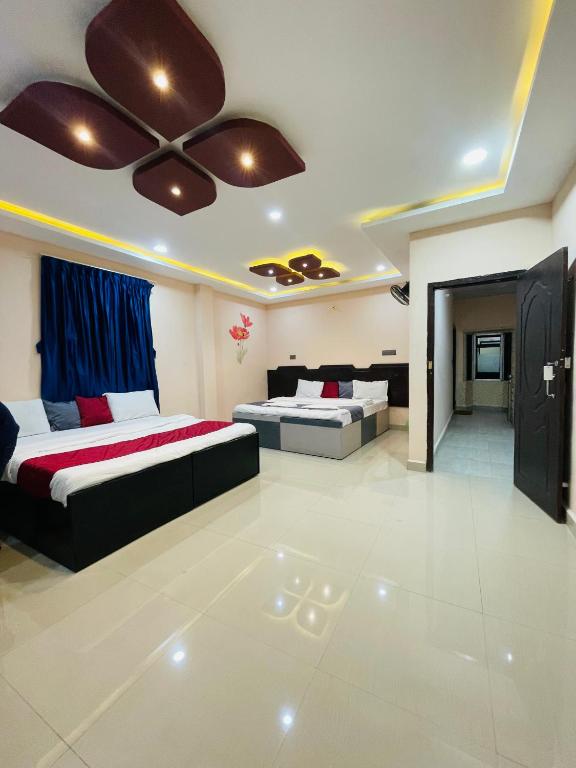 a bedroom with two beds and a ceiling fan at Coorg point in Madikeri