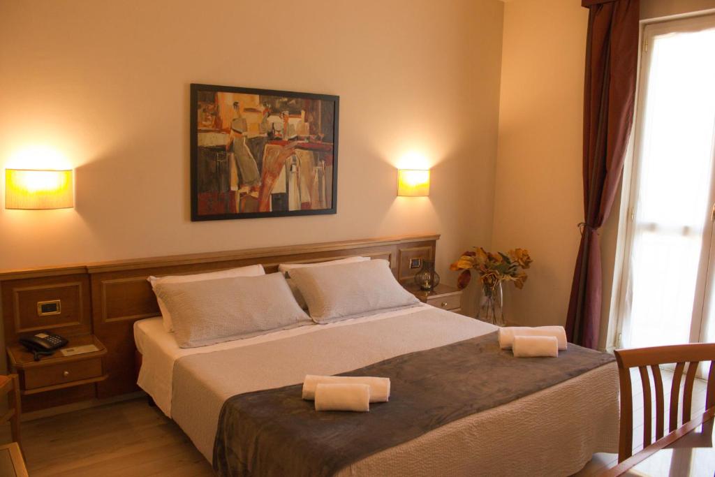 Postel nebo postele na pokoji v ubytování Hotel Valentino