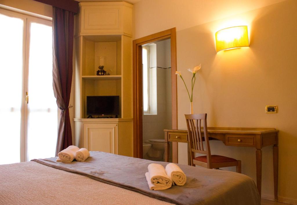 Postel nebo postele na pokoji v ubytování Hotel Valentino