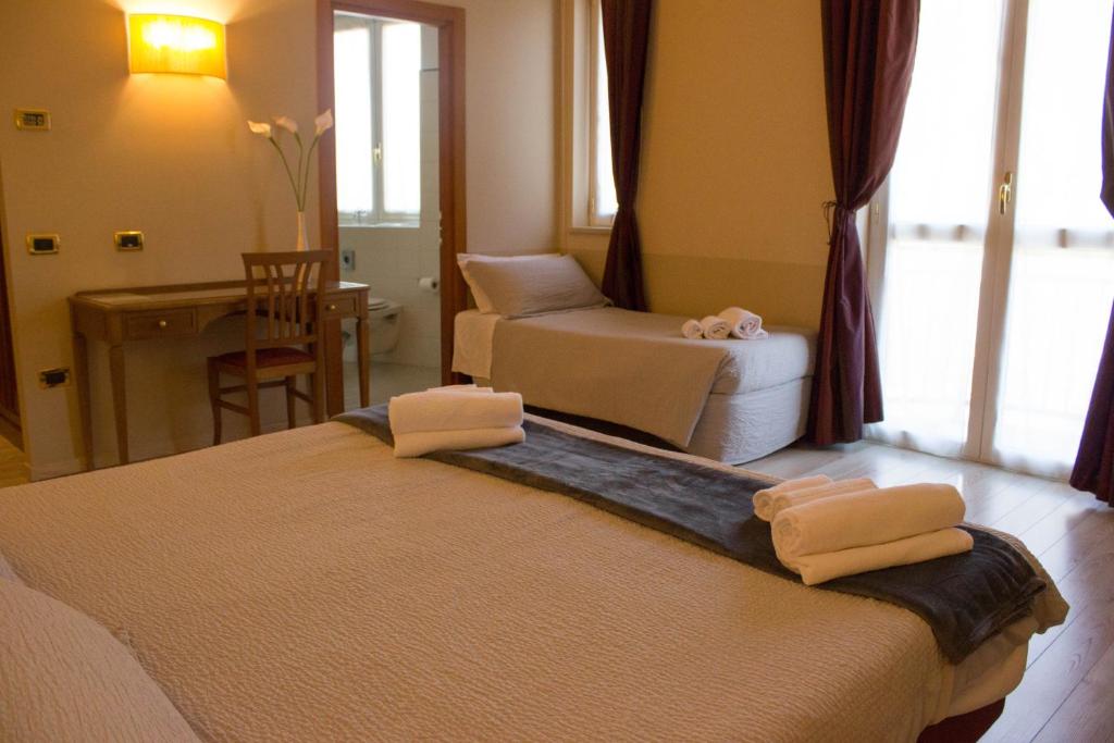Postel nebo postele na pokoji v ubytování Hotel Valentino