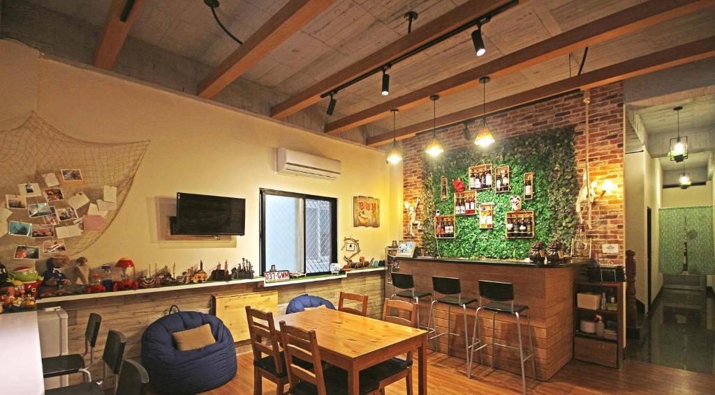 a dining room with a table and a bar at sea monkey diving homestay in Green Island