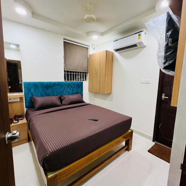 a bed in a small room in a tiny house at Sundaram Residency in Chennai