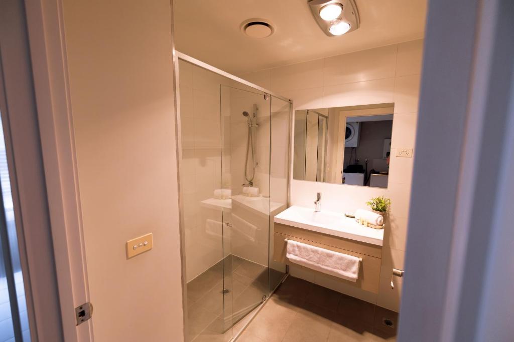 a bathroom with a sink and a shower at The Apollo in Apollo Bay