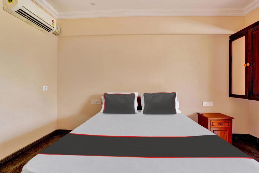 a bedroom with a bed with two pillows at Family Castle Inn in Trivandrum