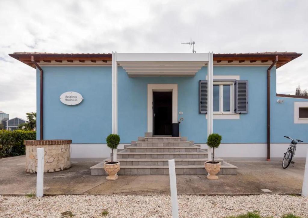 a blue house with stairs in front of it at RESIDENCE MARATTA 54 in Terni