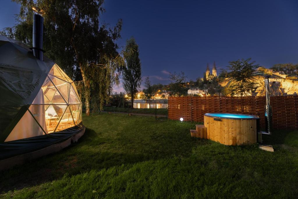 a igloo in the yard of a backyard at night at Glamping escape to the stars under Prague skyline in Prague