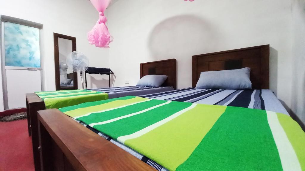Postel nebo postele na pokoji v ubytování Sewana Guest INN
