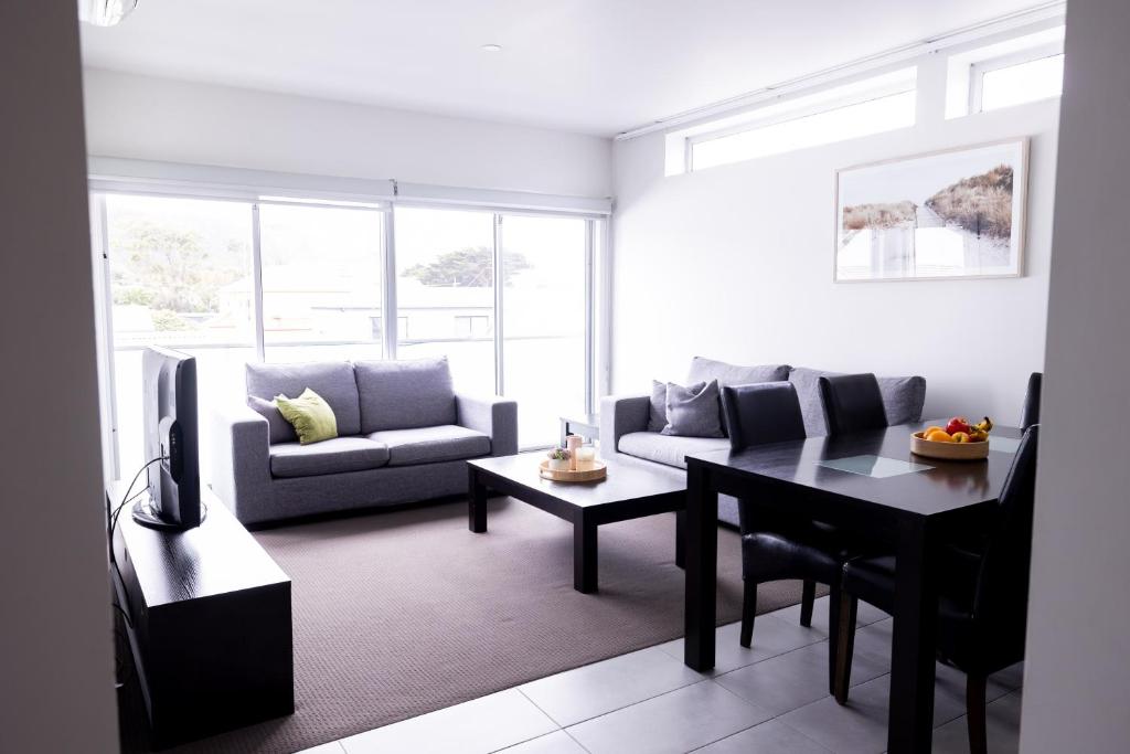 a living room with a couch and a table at The Apollo in Apollo Bay