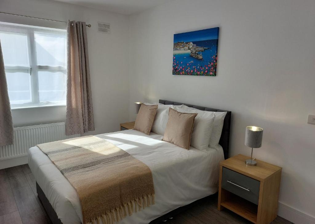 a bedroom with a bed and a picture on the wall at Mountain Aven Guest House in Doolin