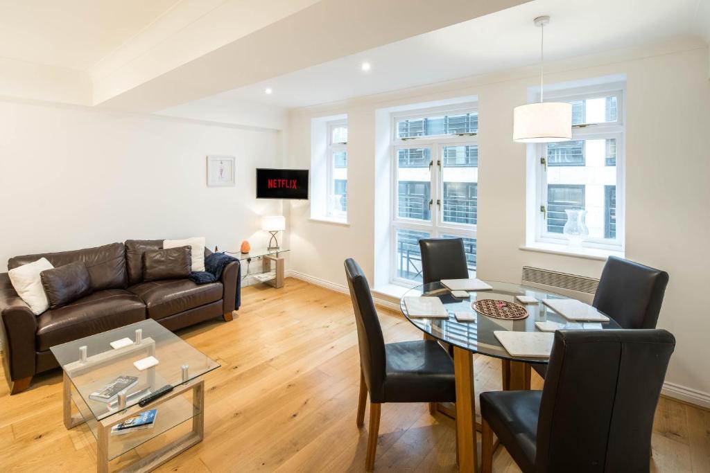 a living room with a couch and a table at 1BD Modern City Oasis: Near London Attractions in London