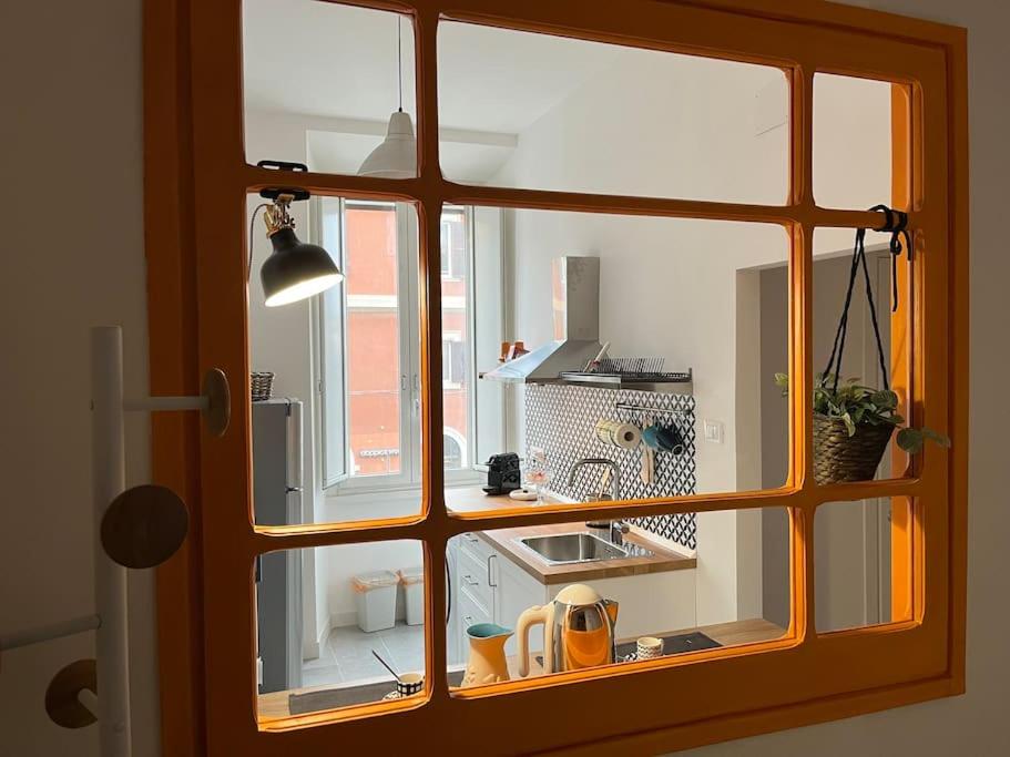 a view of a kitchen through a window at La casa di Monica appartamento Ostiense Roma in Rome