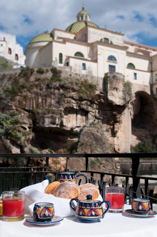a table with plates of food on top of a building at Oasi in Maiori