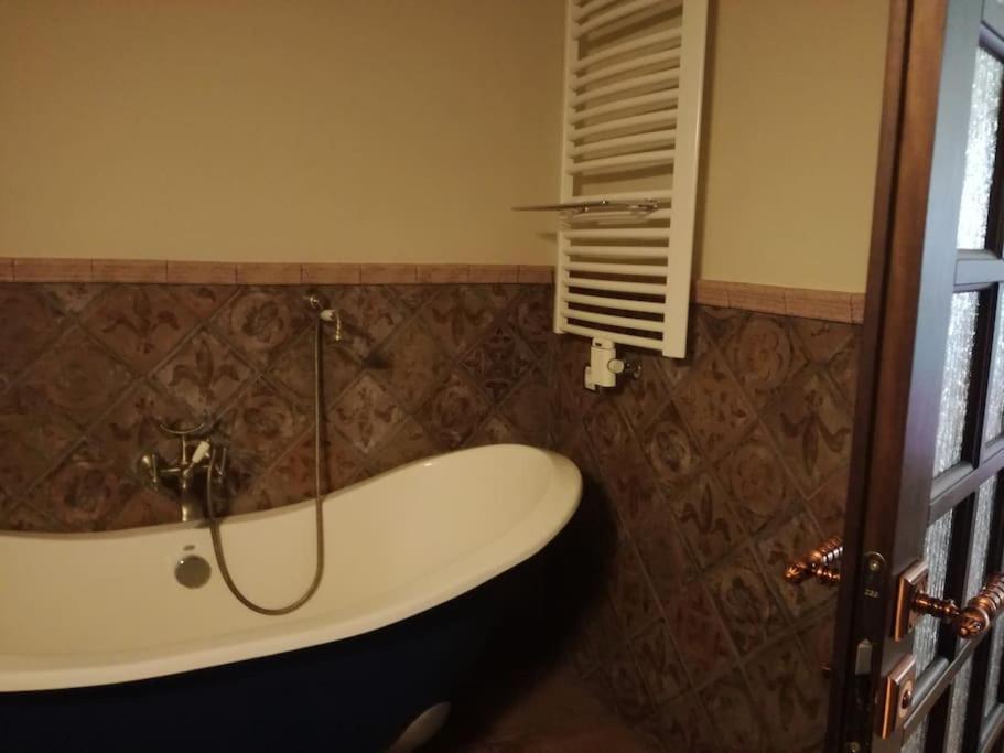 a bathroom with a bath tub and a window at Forest apartment in the loop of the river Neris in Verkšonys