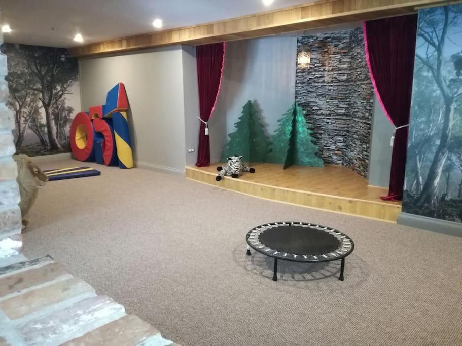 a room with a table in the middle of a room at Forest apartment in the loop of the river Neris in Verkšonys