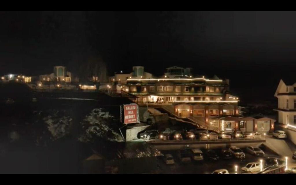 a night view of a large building with lights at Galleu Hill Resort, Kufri Himalayan view resort in Cheog
