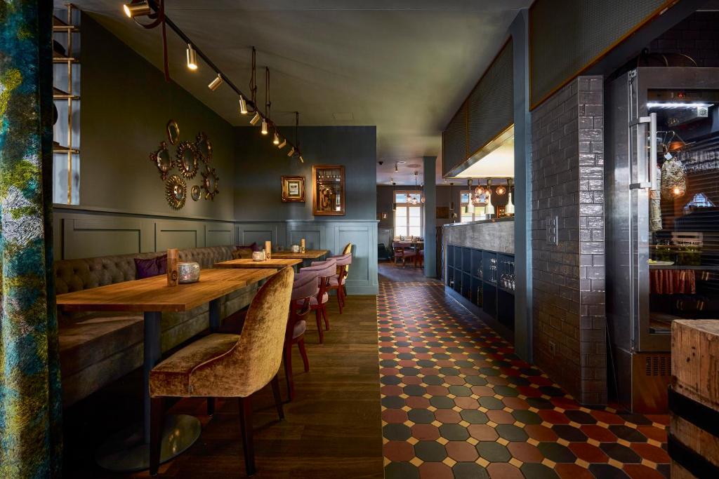 a restaurant with wooden tables and chairs in a room at Boutique Hotel Spedition a member of DESIGN HOTELS in Thun