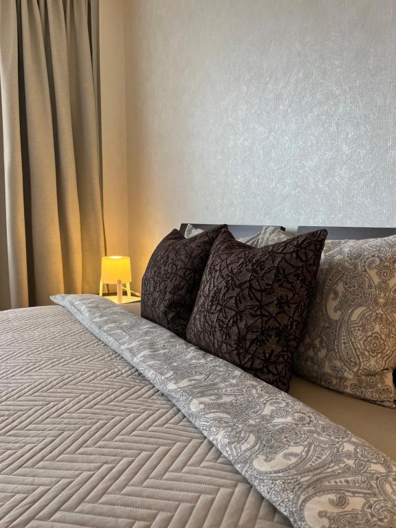 a bed with two pillows on it in a bedroom at Maxima apartments in Daugavpils