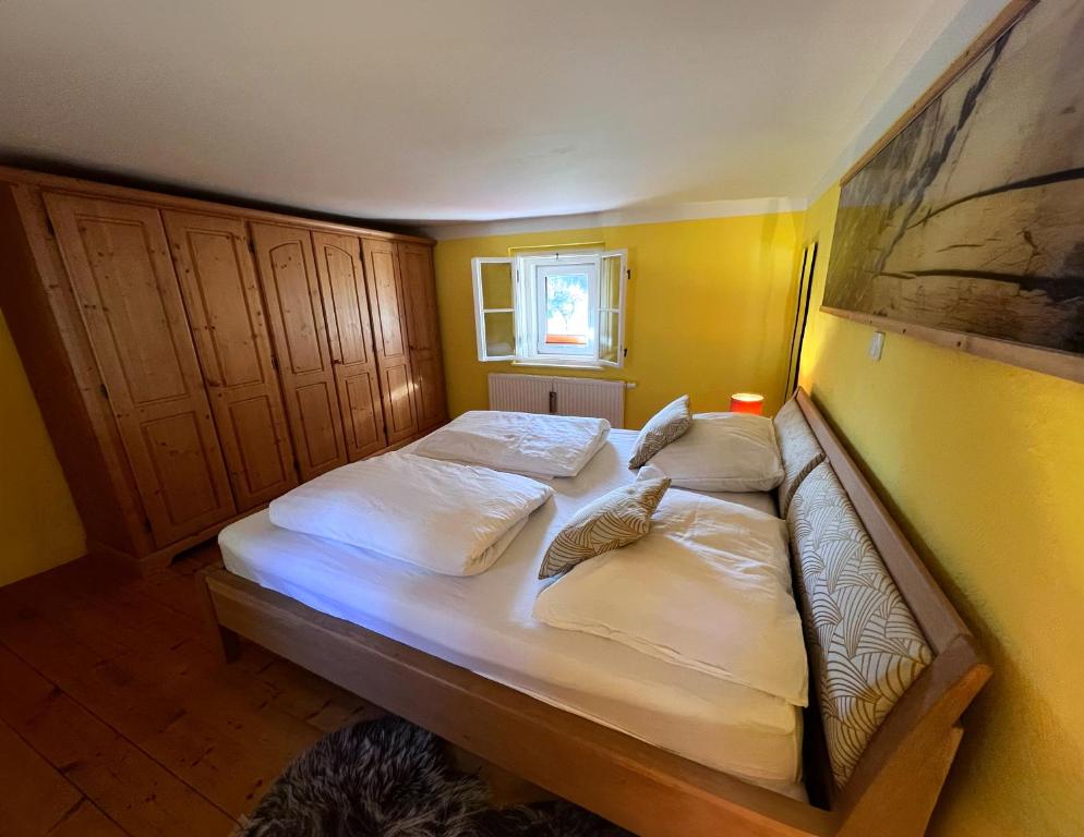 a bedroom with a bed with white sheets and pillows at Haus am Berzdorfer See in Görlitz