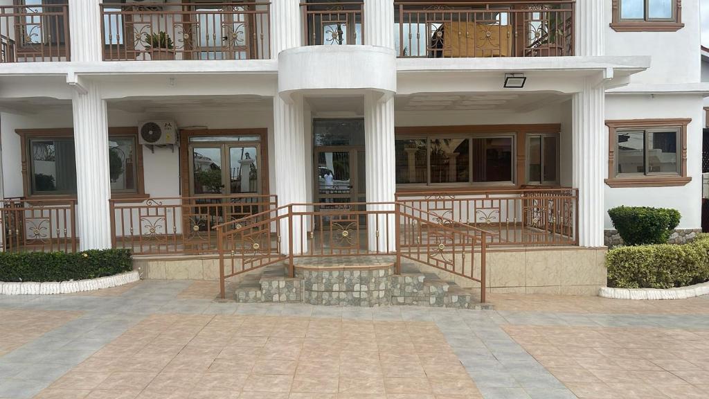 a large building with a staircase in front of it at My5 Hotel in Kumasi