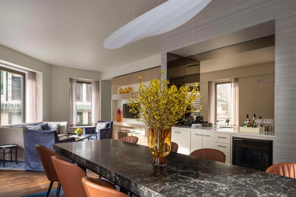 a kitchen with a table with a vase of flowers on it at Hyatt Centric Wall Street New York in New York