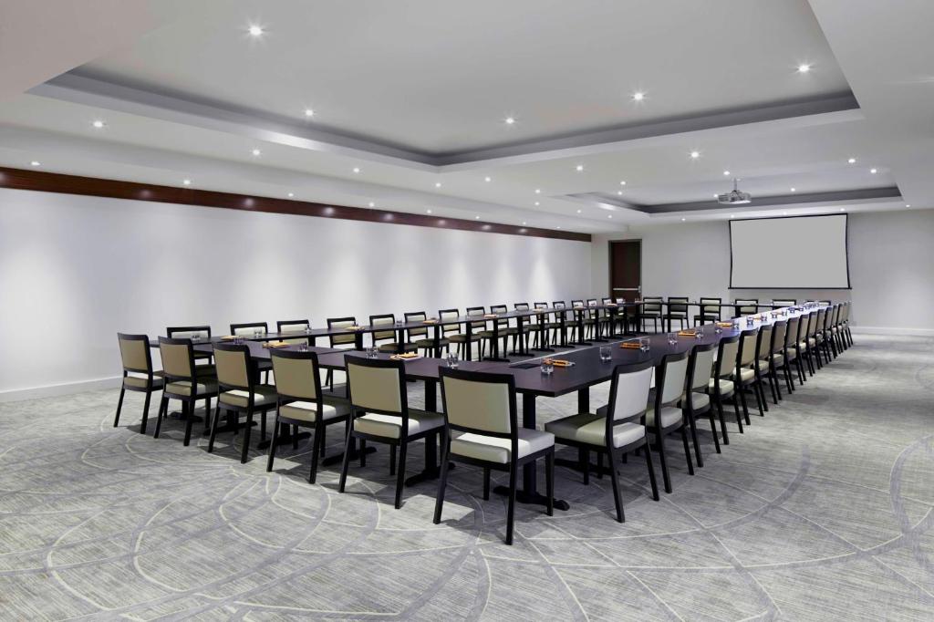 a conference room with a long table and chairs at Hyatt Centric Wall Street New York in New York