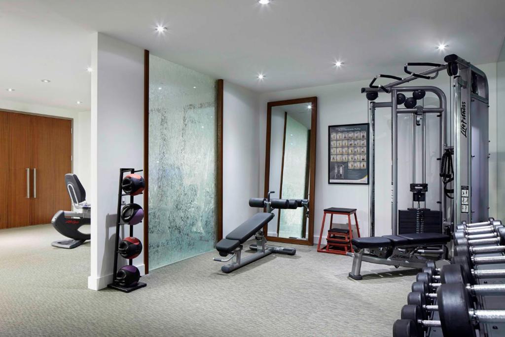 a gym with several treadmills and machines in a room at Hyatt Centric Wall Street New York in New York