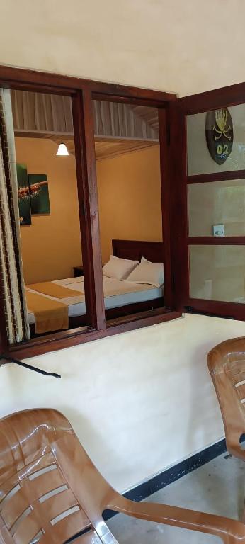 Postel nebo postele na pokoji v ubytování Hôtel Niyagala Lodge Sigiriya