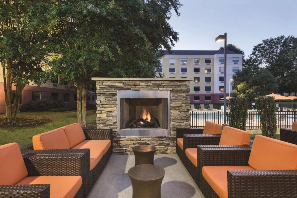 a fire pit with couches and a fireplace at CLT Sky Suites in Charlotte