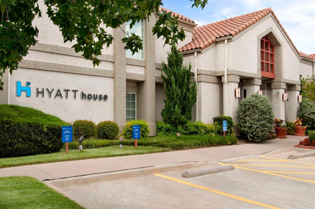 a building with a ivatt homes sign in a parking lot at Hyatt House Dallas Las Colinas in Irving