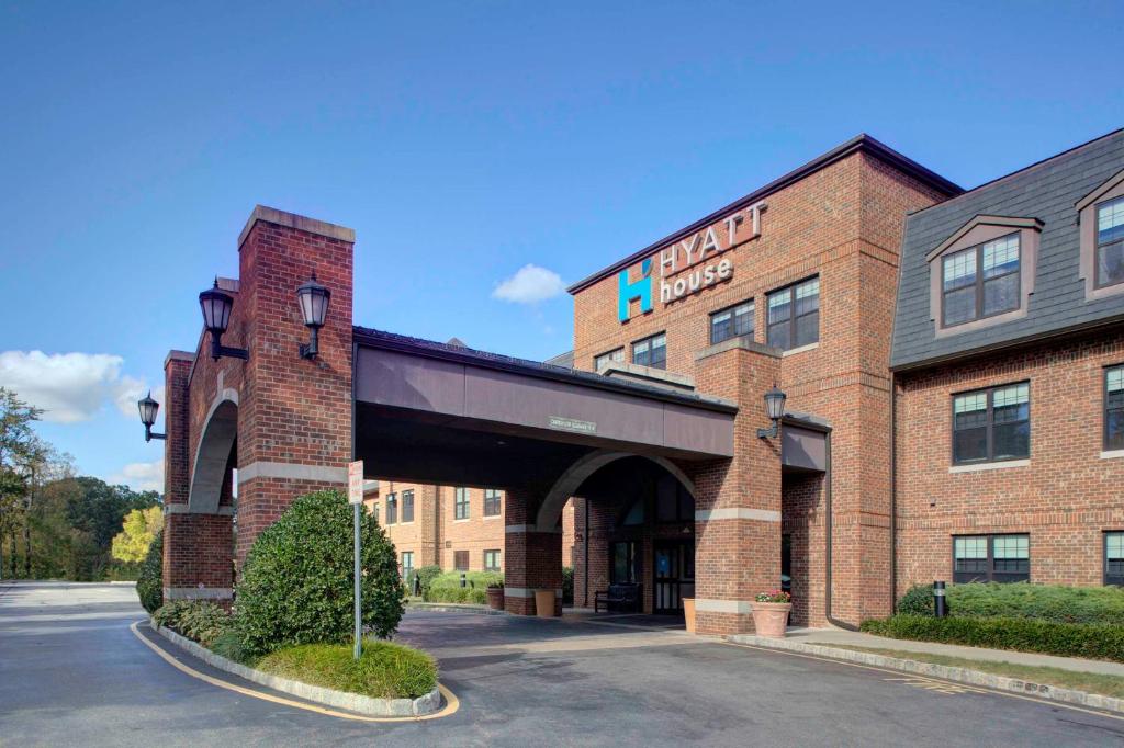 a brick building with an archway in a parking lot at Hyatt House Parsippany East in Parsippany