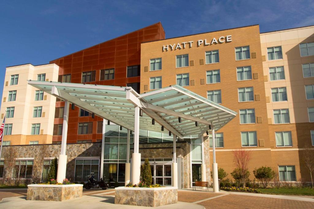 a hotel building with a metal canopy in front of it at Hyatt Place Charlottesville in Charlottesville