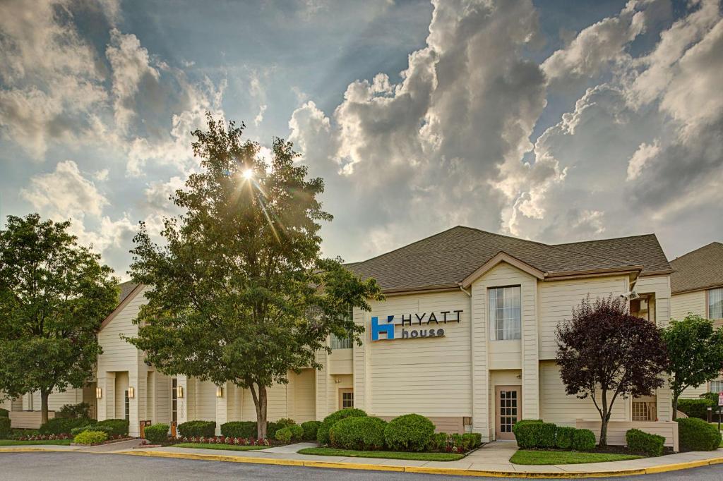 a hotel with a sign on the front of a building at Hyatt House Mount Laurel in Mount Laurel