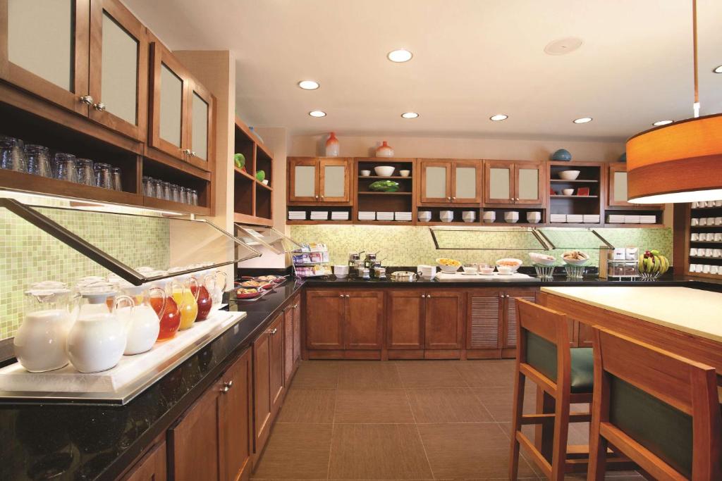 a large kitchen with wooden cabinets and a counter at Hyatt Place Columbus/OSU in Columbus