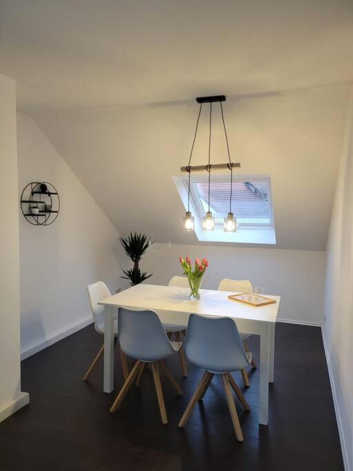 a dining room with a white table and chairs at Ruhige Ferienwohnung auf dem Land in Starzach