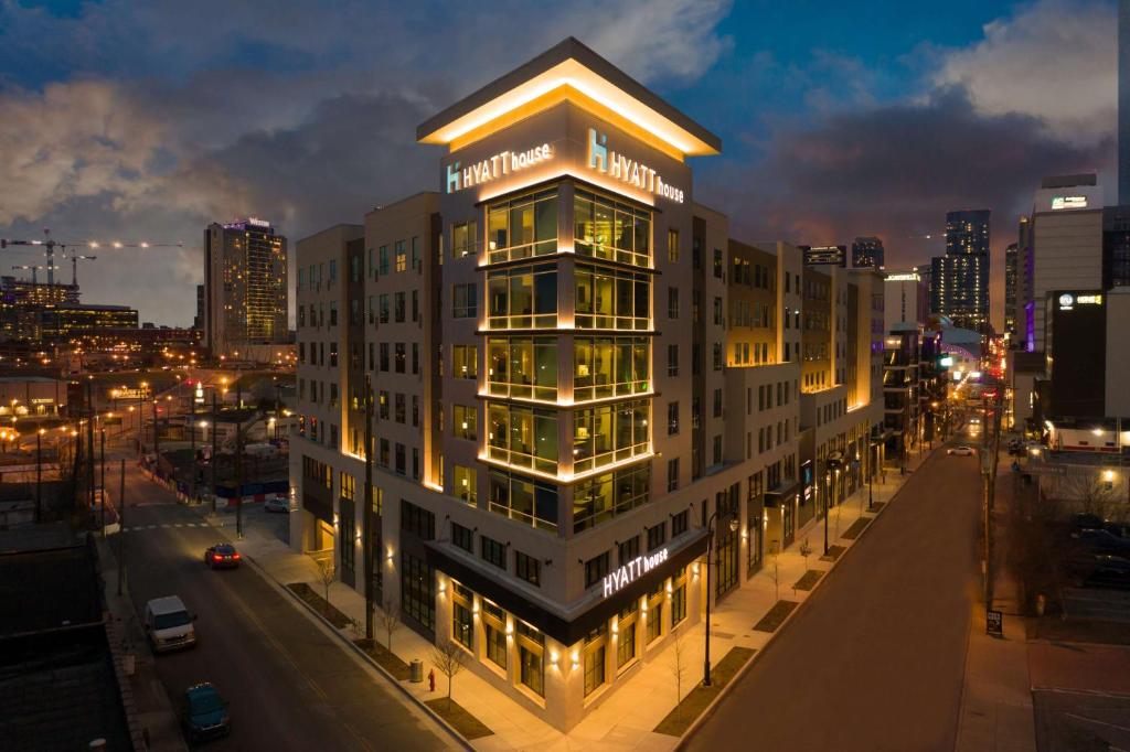 a tall building with lights on in a city at night at Hyatt House Nashville Downtown-Convention Center in Nashville