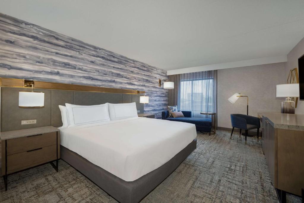 a hotel room with a large bed and a desk at DoubleTree by Hilton Kingston in Kingston