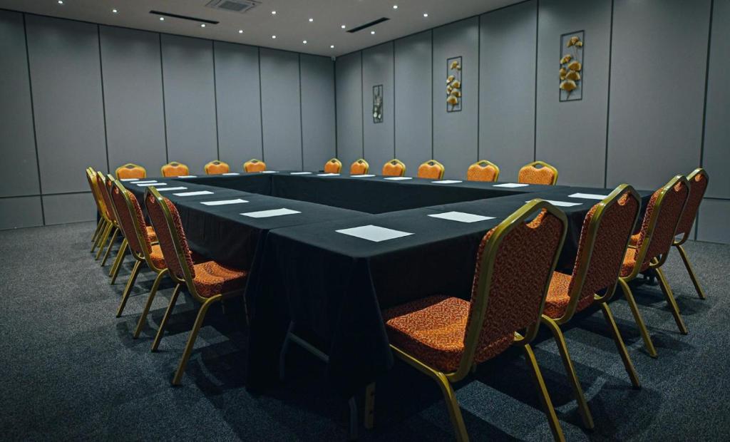 a conference room with a long table and chairs at Ador Hotel North Mitrovica in Mitrovicë