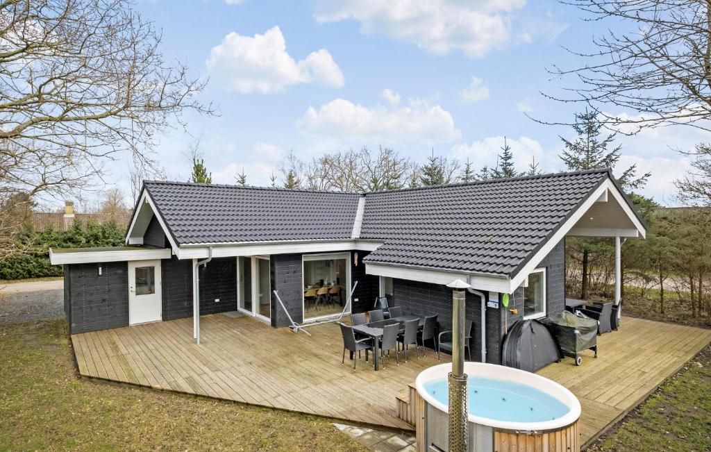 a small house with a deck and a patio at Lovely Home In Hadsund With Kitchen in Hadsund