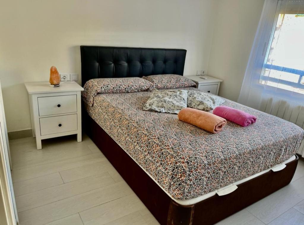 a bedroom with a bed with two pillows on it at Apartamento Cuidad Ciencias in Valencia