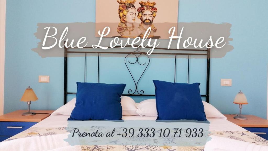 a bed with a blue luxury house sign on it at Blue Lovely House in San Vito lo Capo