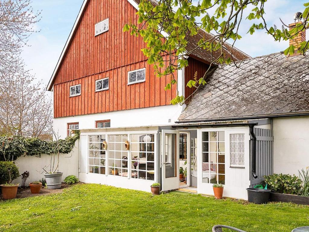 a large white house with a red roof at Holiday home Klagstorp in Klagstorp