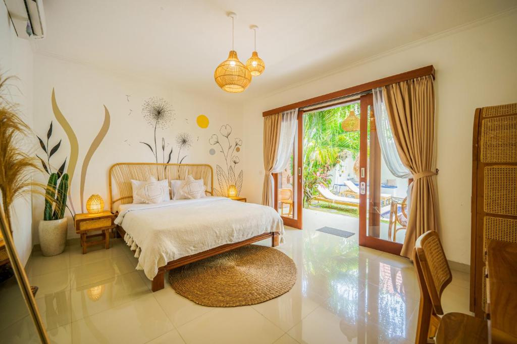 a bedroom with a bed and a large window at Shortcut Breeze Guest House in Canggu