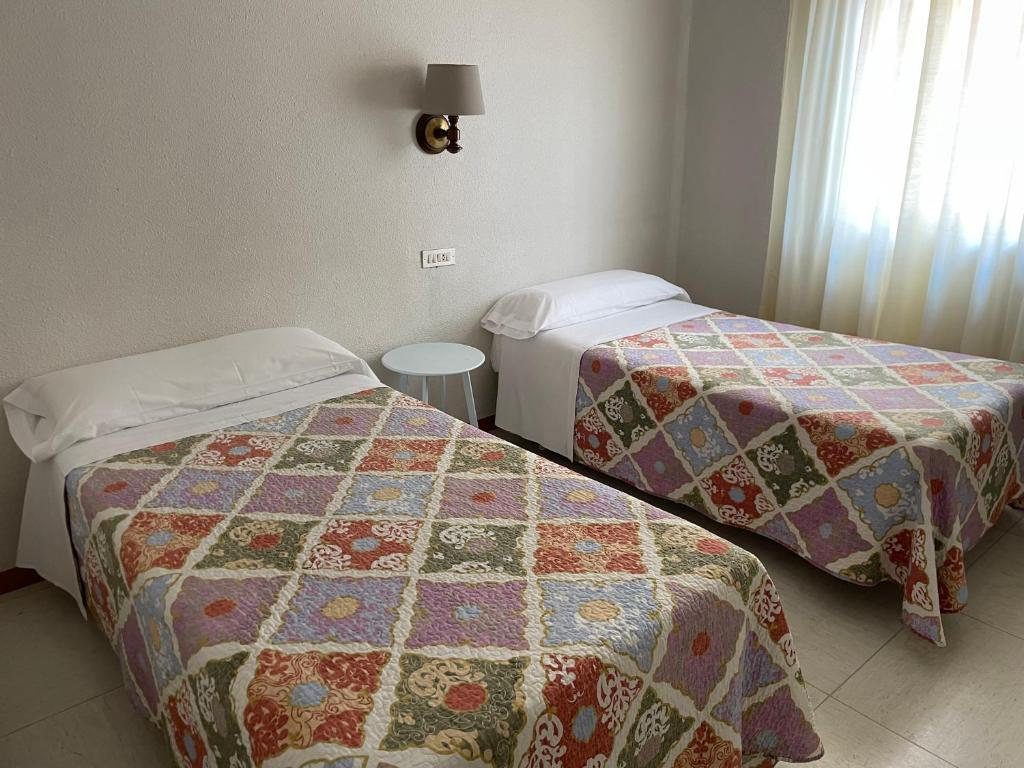 Postel nebo postele na pokoji v ubytování Hostal Ochoa