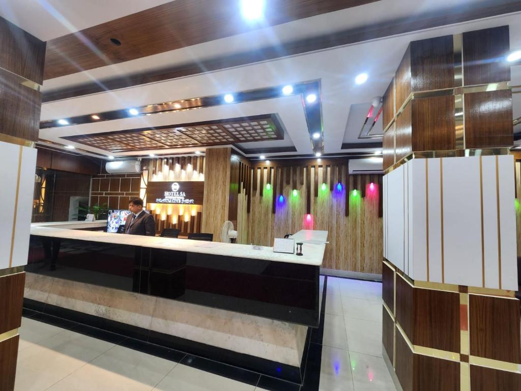 a lobby of a hotel with a bar at Hotel S.A International in Cox's Bazar