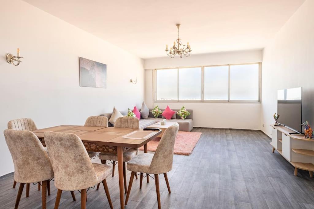 a dining room with a table and chairs at Appartement neuf, luxe et vue panoramique de Rabat in Rabat