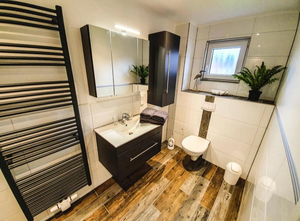 a bathroom with a sink and a toilet at Haus Seeschwalbe Borkum in Borkum